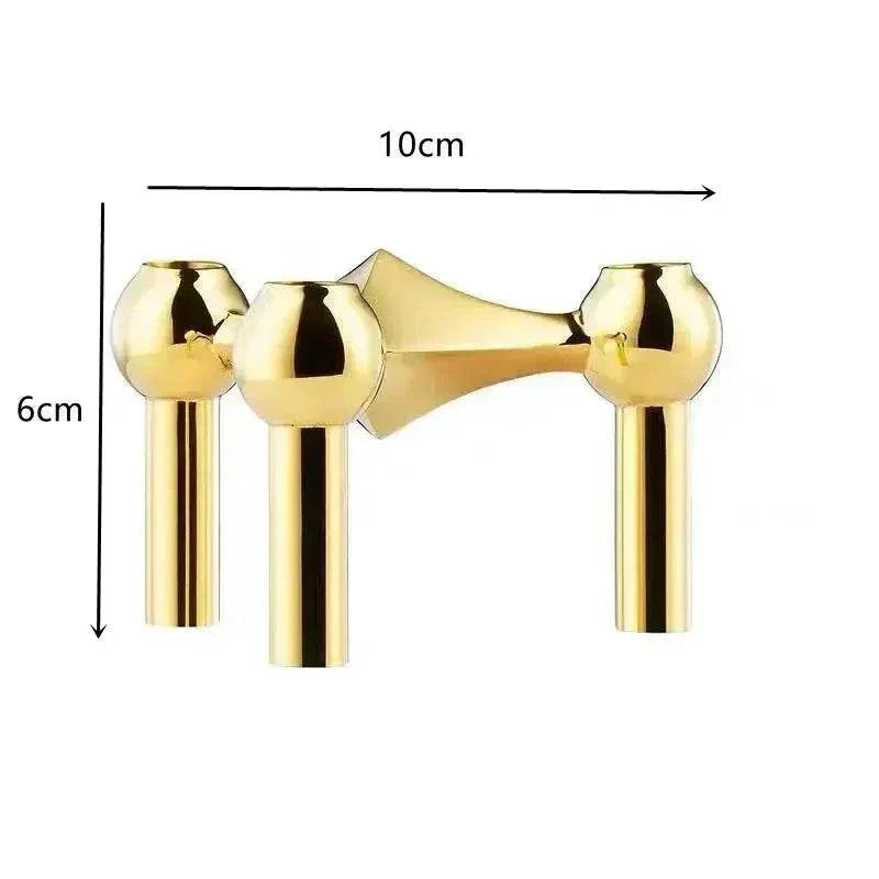 Metal sculptural candle holder with modular arms and polished gold finish, ideal for modern decor.