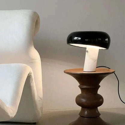 Snoopy Lamp with black mushroom-shaped shade on white cylindrical base, next to modern furniture.