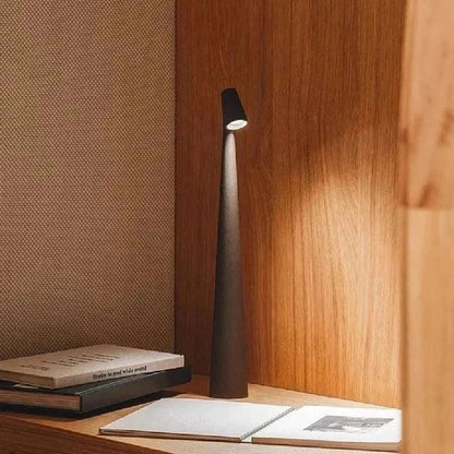 Portable LED Light with touch sensor on wooden surface, sleek conical base design.