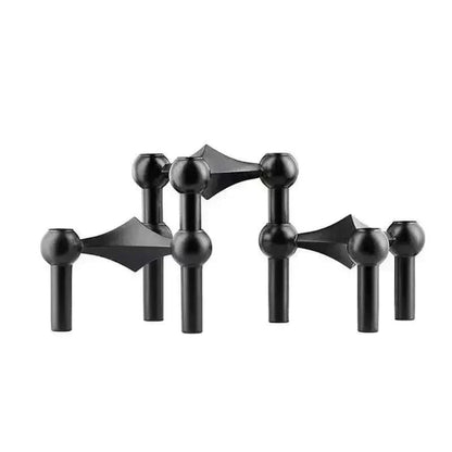 Modern metal sculptural candle holder with modular arms and elegant design.