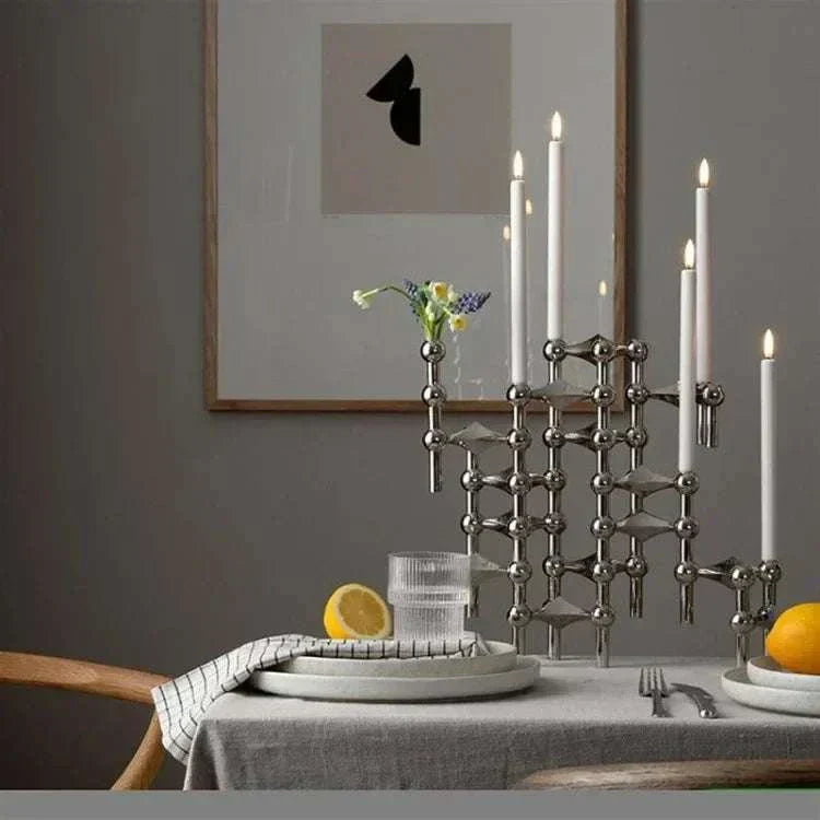 Modern metal sculptural candle holder with polished modular design, elegant centerpiece for home decor.