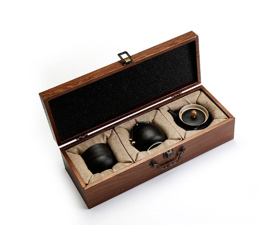 Traditional Japanese tea set in a wooden box with textured teapot and teacups.