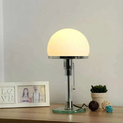 Bauhaus Lamp with dome-shaped shade on a sleek metal stand, featuring a cylindrical base and pull chain switch, adding elegance to modern decor.