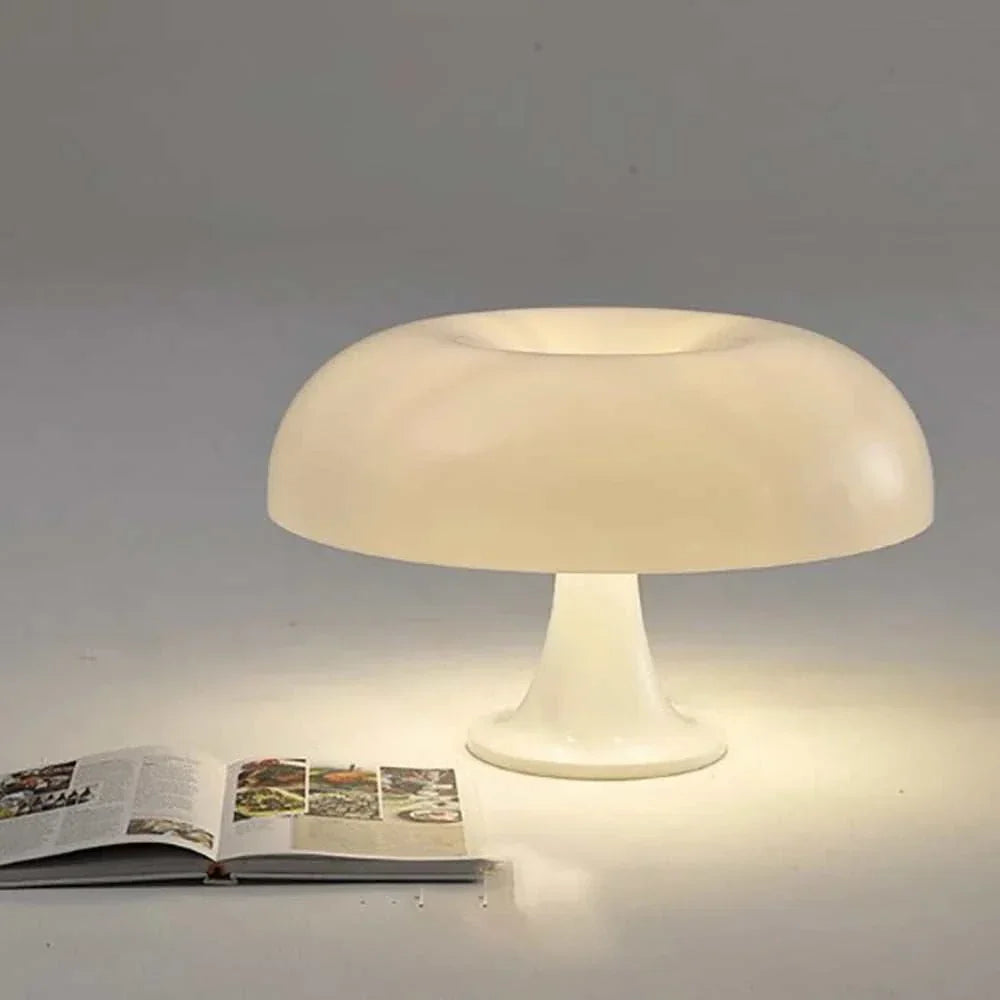 Mushroom Table Lamp with sleek dome design illuminating open book on a table.