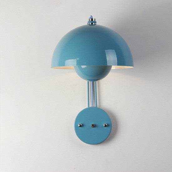 Flowerpot Lamp wall with blue dome-shaped shade mounted on a wall, offering a sleek and elegant design.