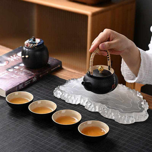 Traditional Japanese tea set with textured teapot and teacups on display.